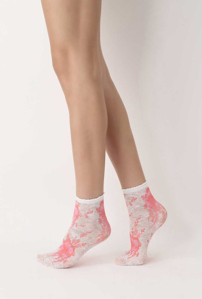 Lady's feet walking in white and coral floral socks.