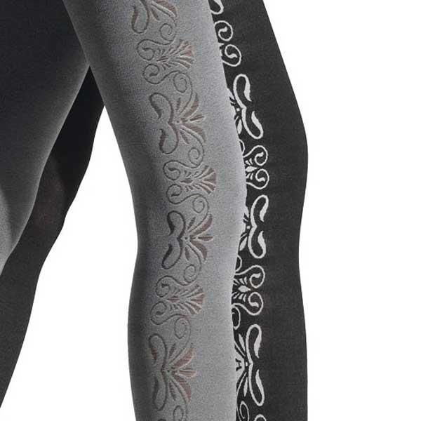 Close up of two striding legs, in contrasting reversible patterned tights, grey self-pattern next to black and white geometric design, legs shown from mid-thigh to mid-calf.