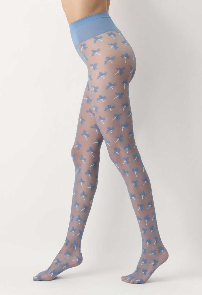 Side view of lady's legs walking stance, wearing light blue sheer tights, patterned with flowers. 