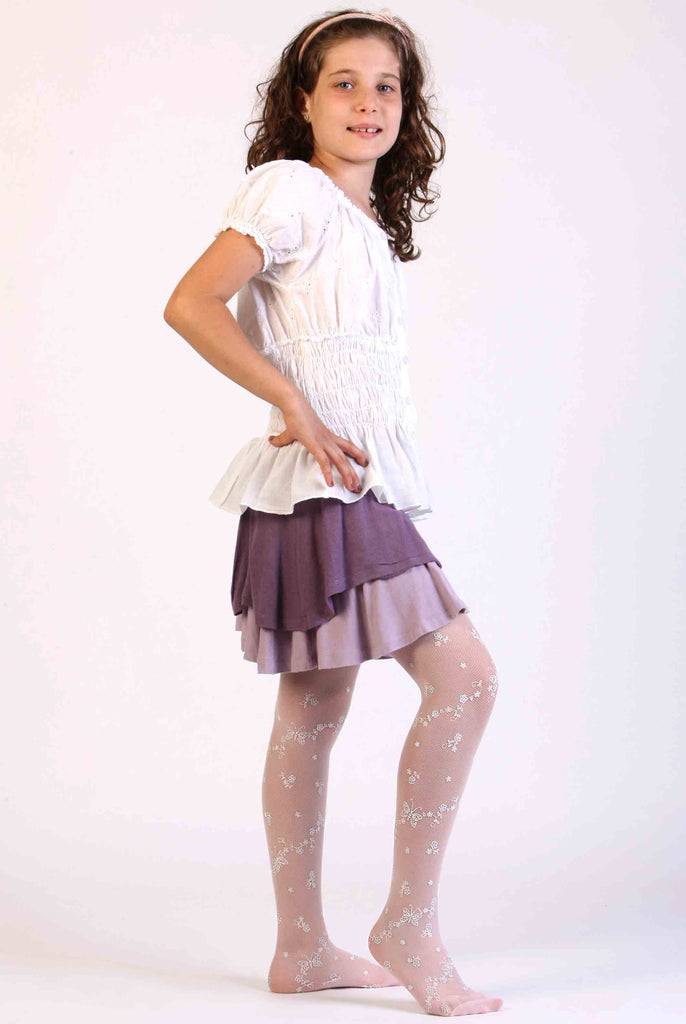 Child displaying her white tulle mesh tights on her legs.