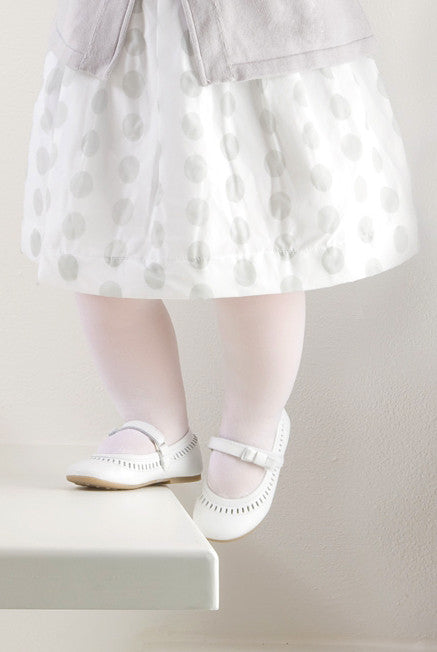 close up of baby girl's feet as she walks up a step.