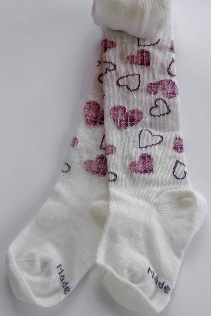 White toddler tights rolled at top with legs and feet showing pink heart pattern.
