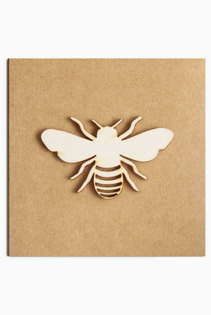 Wooden cut out bee on light brown kraft card.