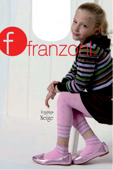 Young girl sitting wearing pink polka dots footless tights and bright striped jumper.