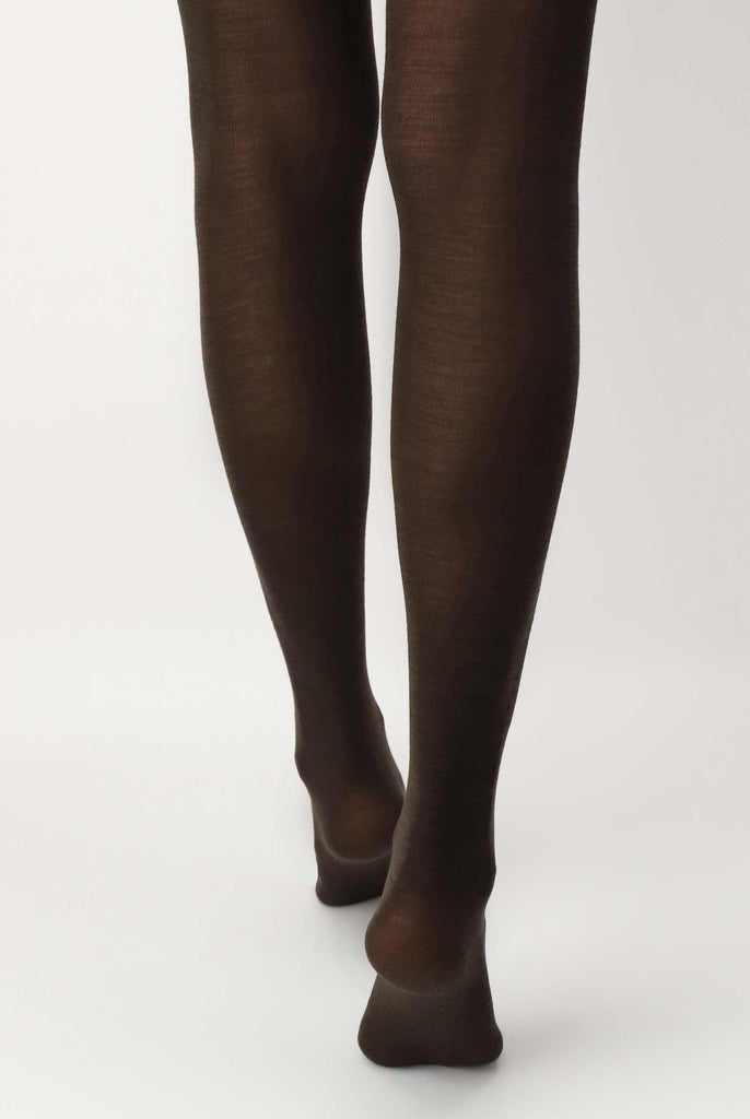 Back view of lady's lower legs in brown tights.