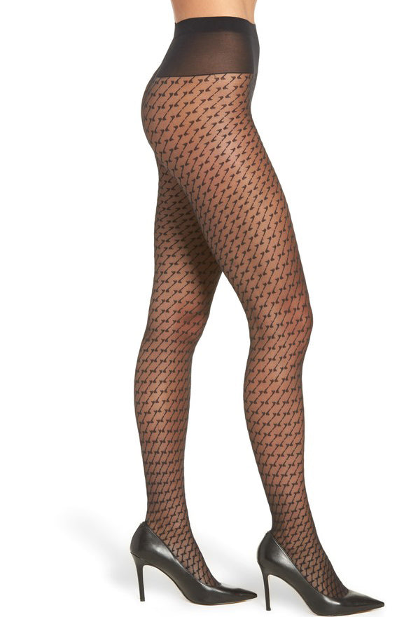 Photo of a side view of ladies legs wearing black geometric patterned tights and black high heeled shoes