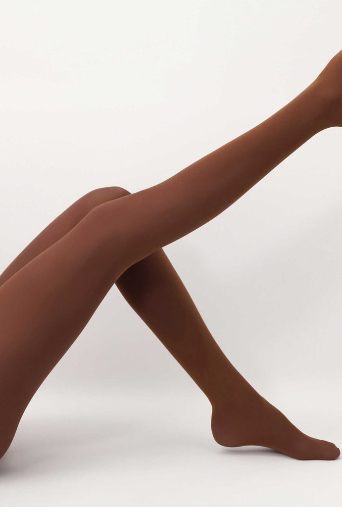 Lady's leg outstretched, wearing brown caramel tights.