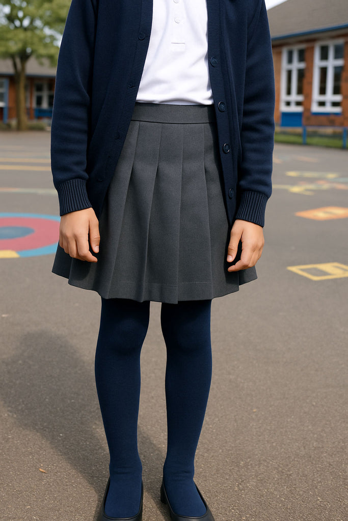 Girls standing in a schoolyard and wearing a school uniform.