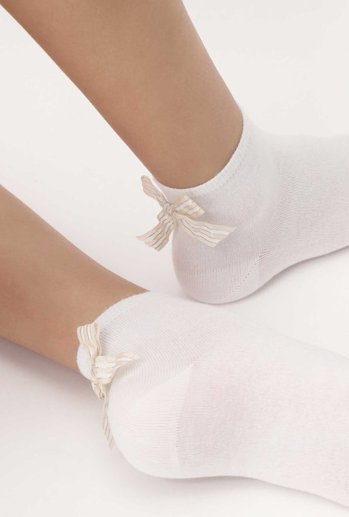 Lady's feet in white ankle socks with pretty striped back bow