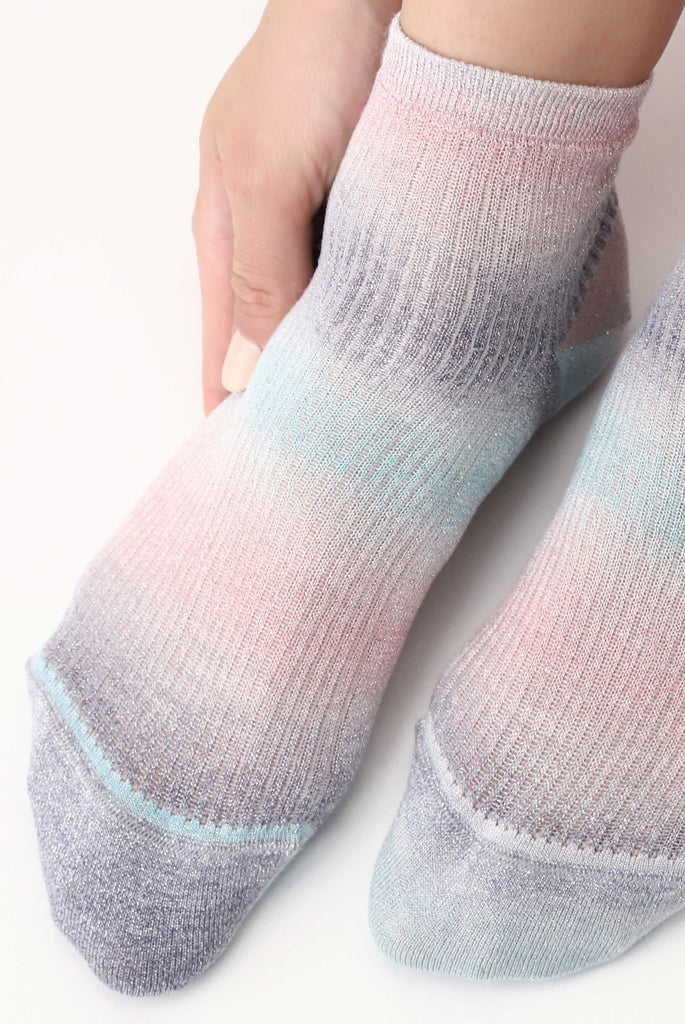 Close up of lady's feet wearing multicoloured ankle socks.