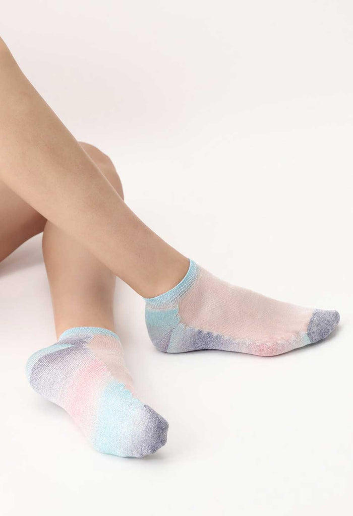 Close up of lady's feet in multicoloured sneaker socks.