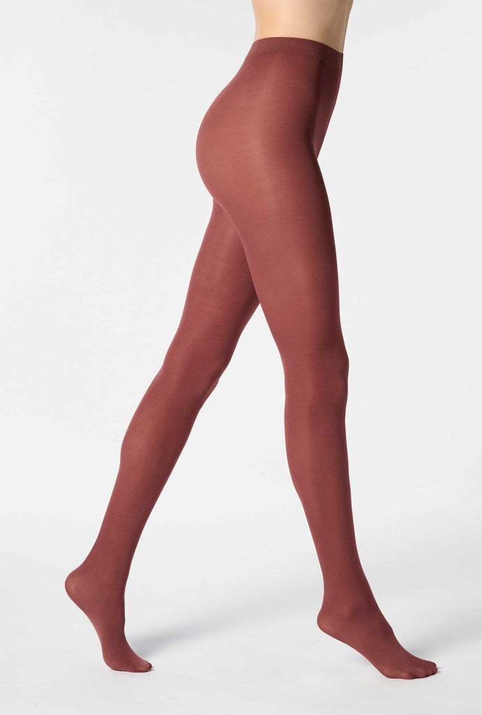 Side view of lady's legs, walking in mocha brown tights.