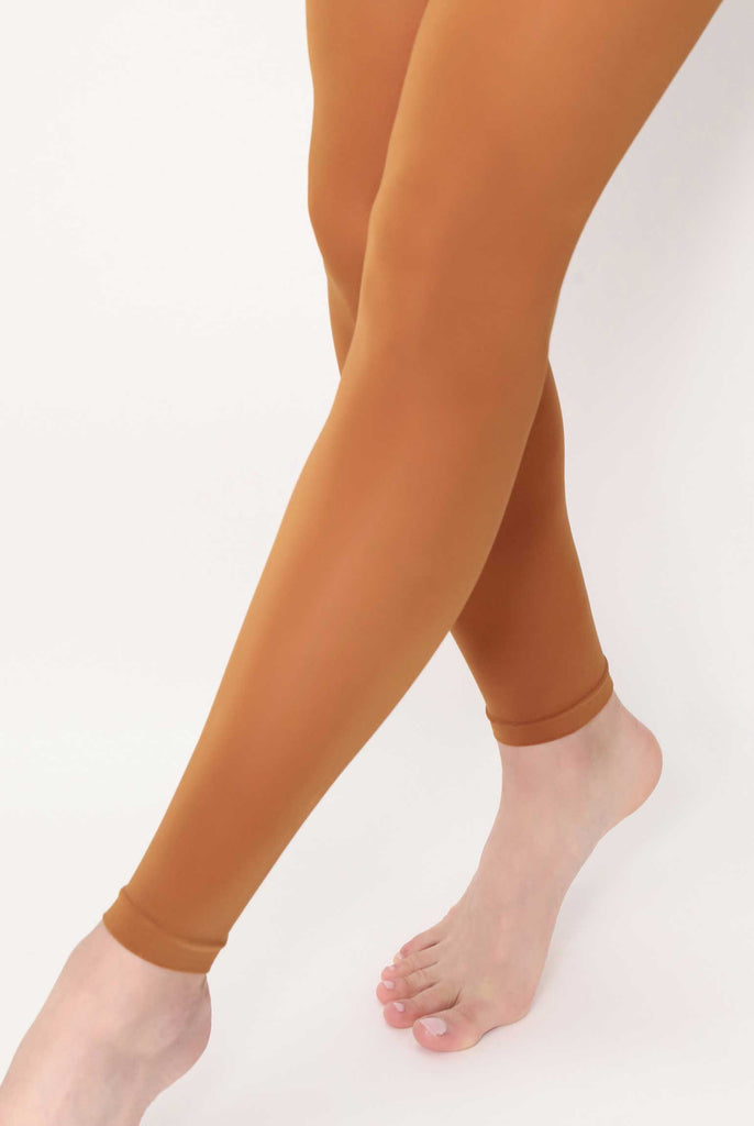 Close up of lady's lower legs and feet, wearing sienna brown footless tights.