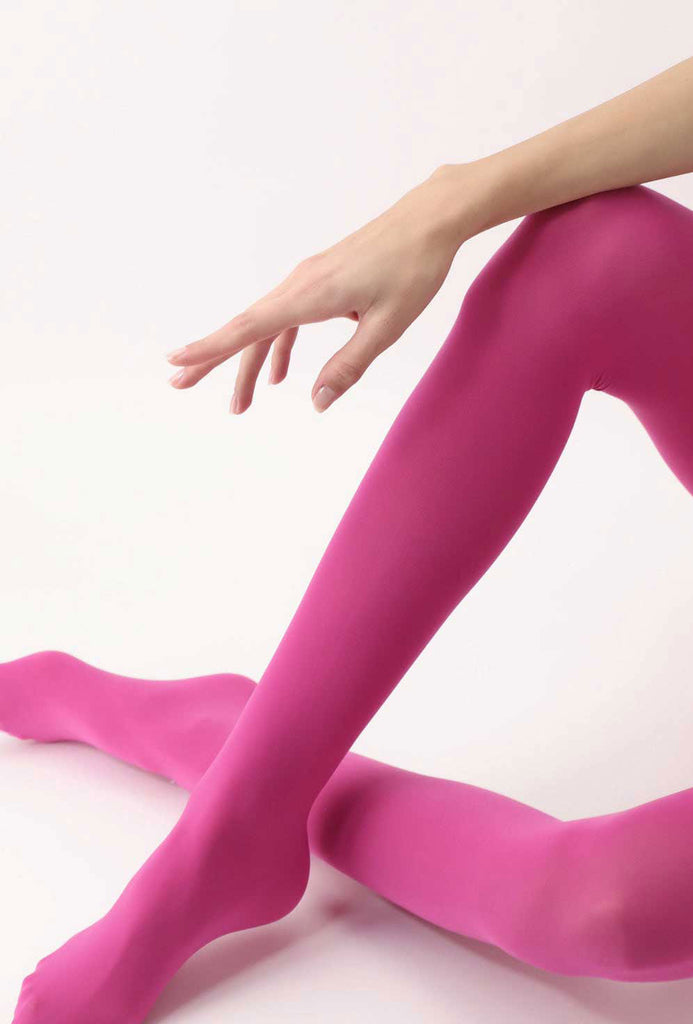Lady's knees and lower legs in crossed over position, wearing hot pink tights.