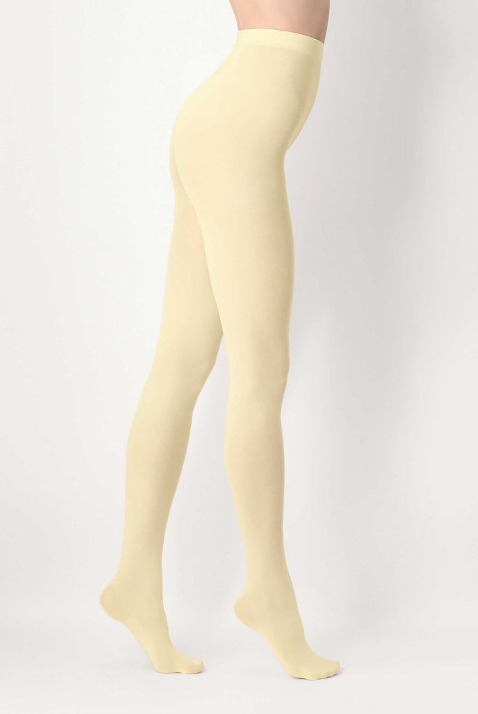 Side view of lady's legs wearing vanilla cream tights.