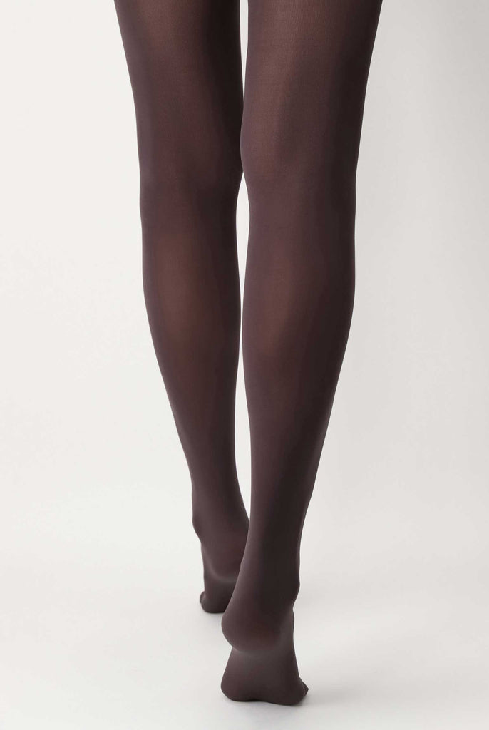 Back view of lady's legs wearing brown tights.