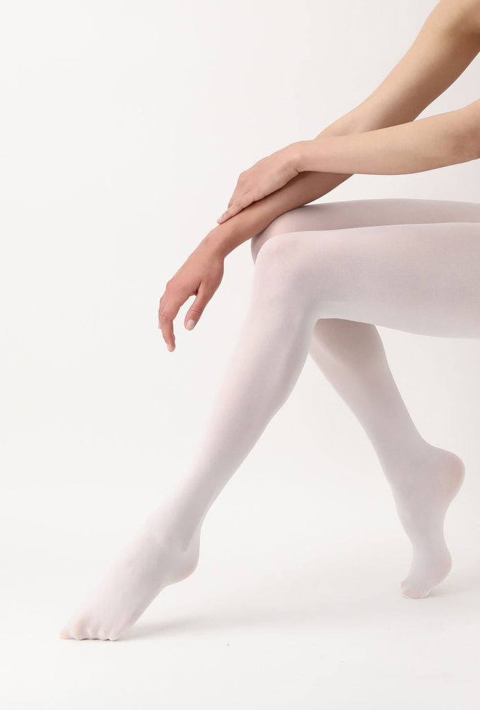 Ladies legs, outstretched and bent at the knees in white tights.