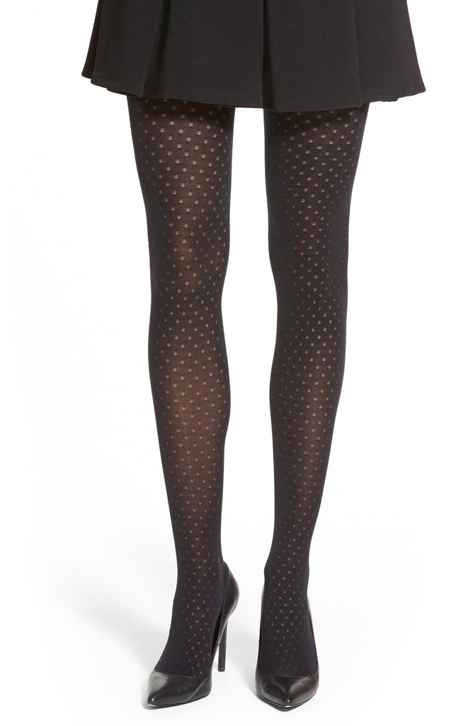 Front view of lady's legs from the thigh down, in black eyelet tights and shoes.