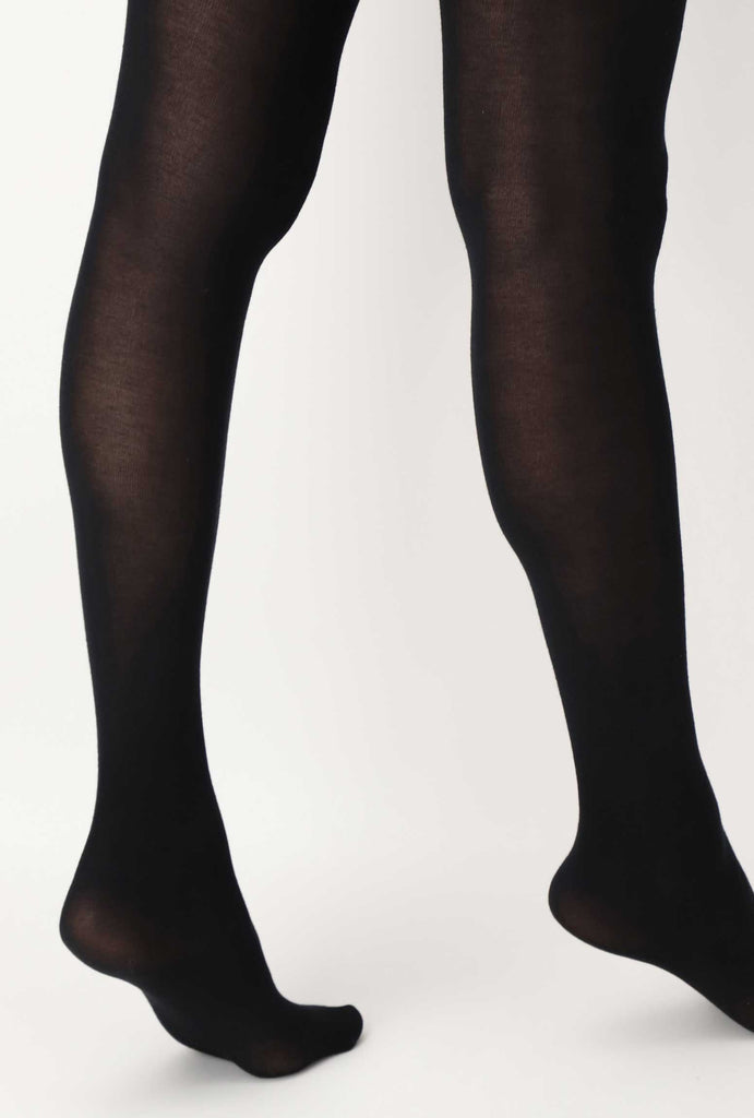 Back view of lady's lower legs wearing black  tights.