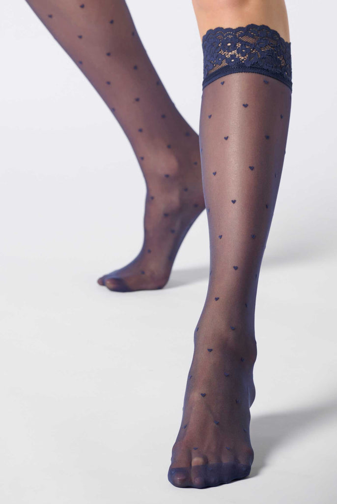 Front view of lady's lower legs wearing blue sheer heart patterned socks.