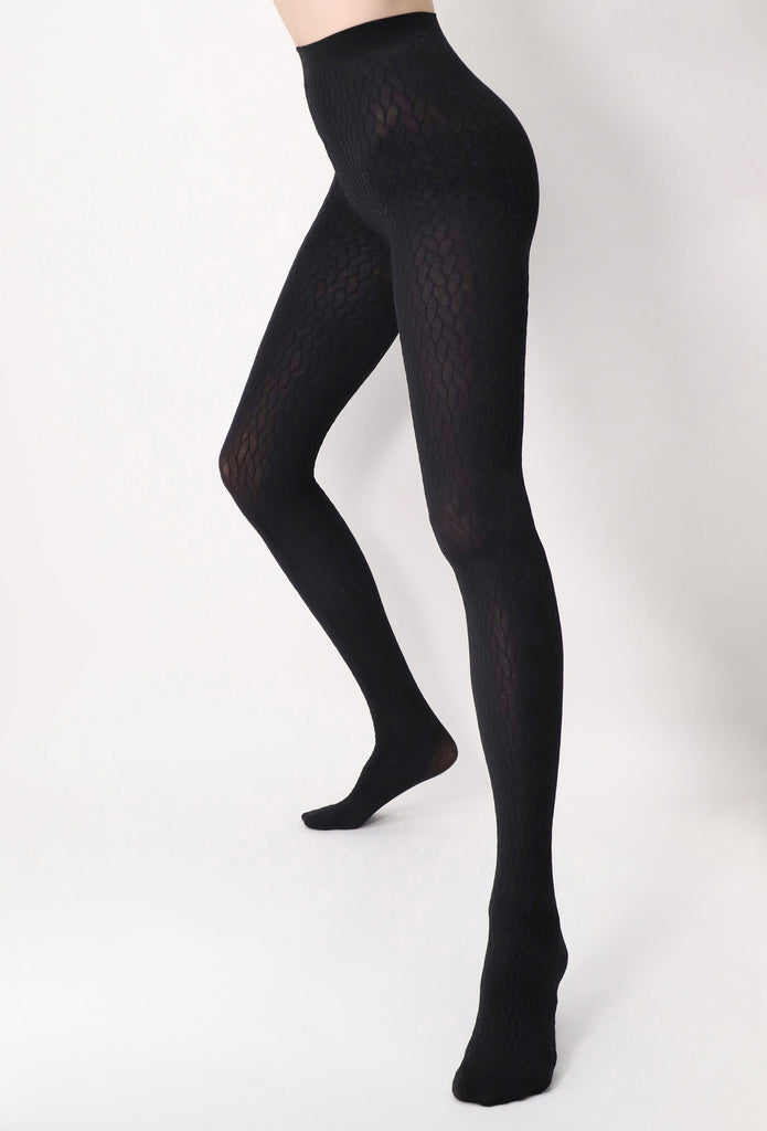 Lady's legs, standing with feet apart wearing black pattern tights.