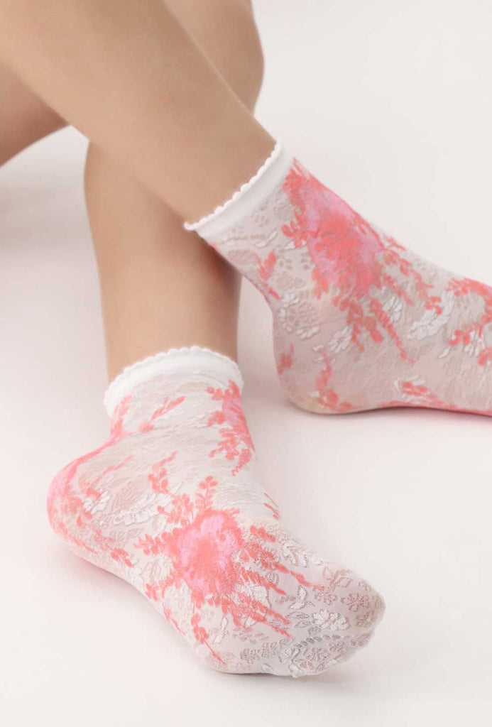 Close up of lady's feet in white and coral socks.