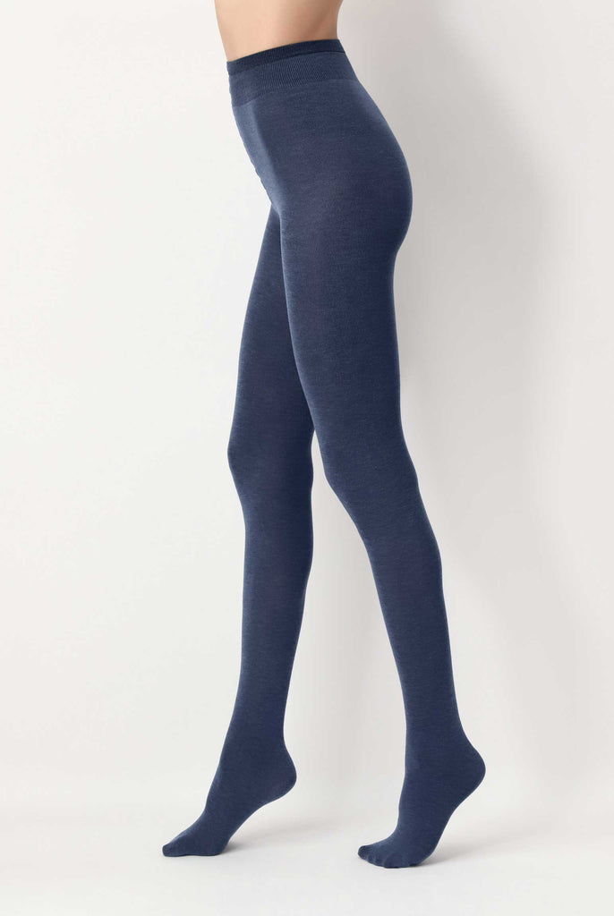 Side view of lady's legs wearing blue jeans coloured tights.