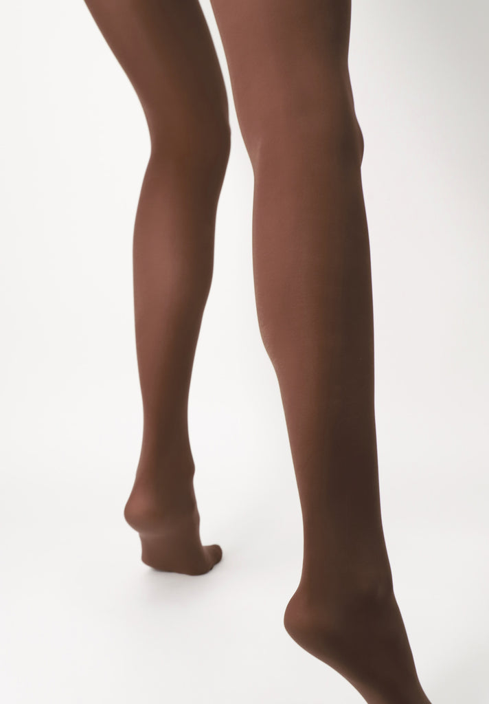 Back view of lady's lower legs, wearing caramel coloured tights.