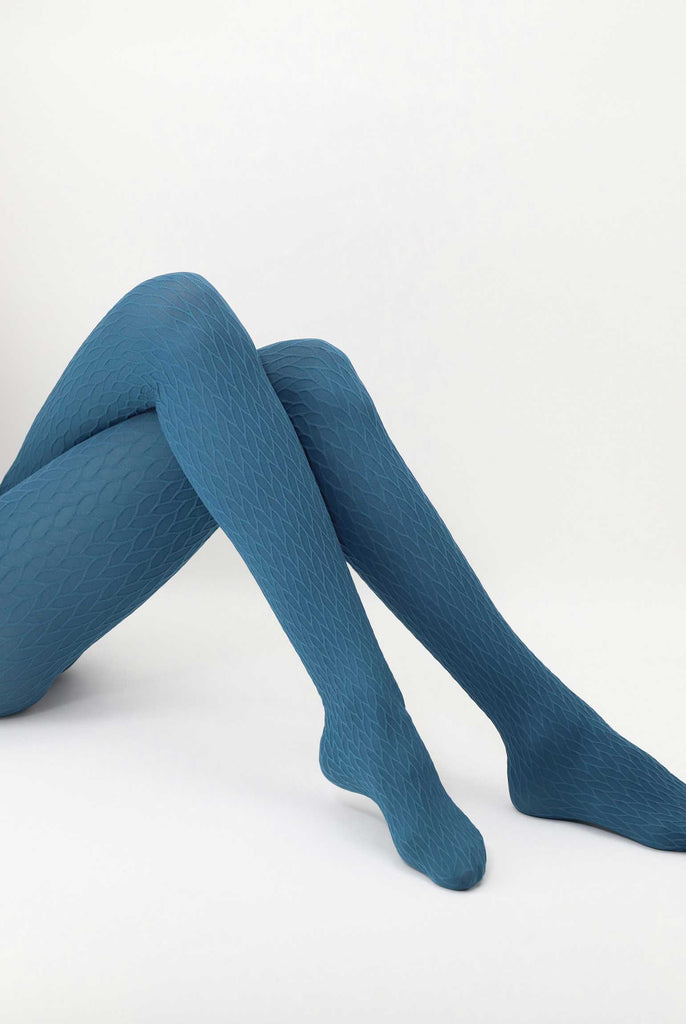 Lady's lower legs, outstretched and crossed at the knee, wearing cobalt blue tights.