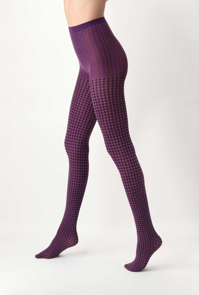 Side view of lady's legs in purple and black dot tights.
