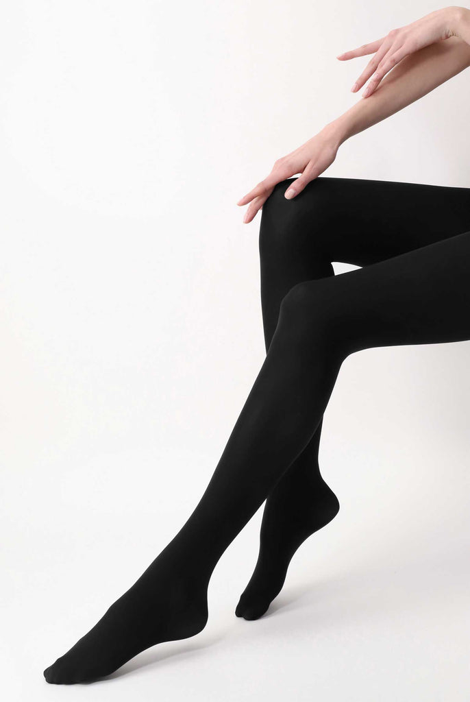 Side view of lady's lower legs, wearing black tights.