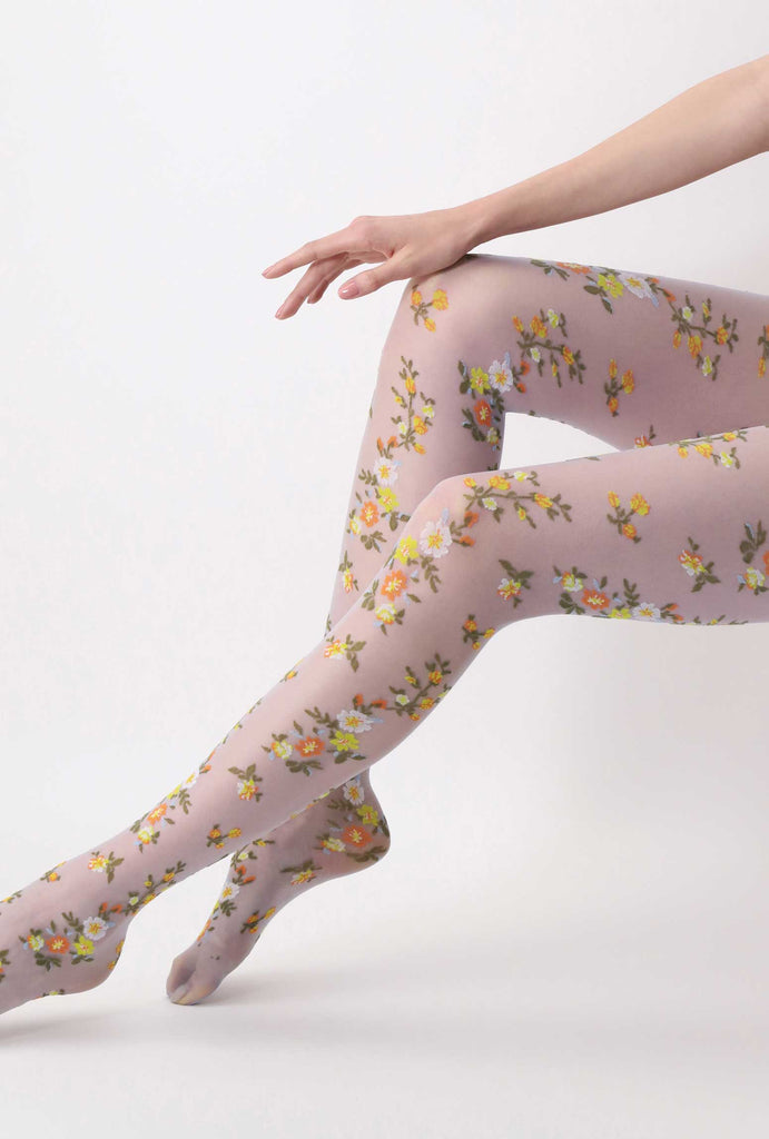 Lady's legs outstretched wearing floral sheer tights.