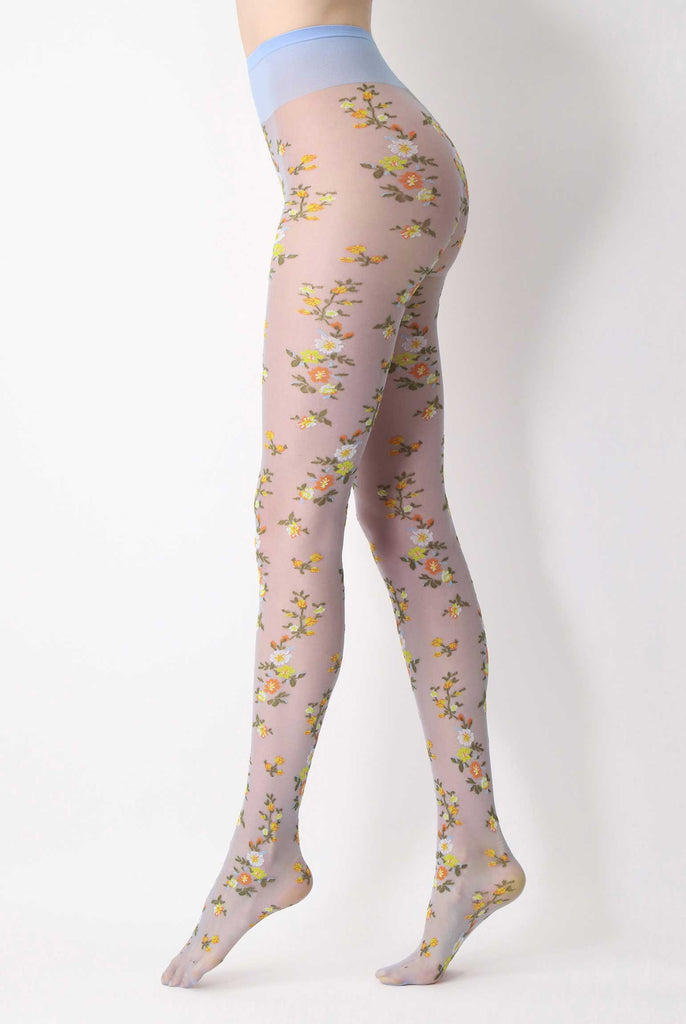 Side view of lady's legs in light blue sheer floral patterned tights.