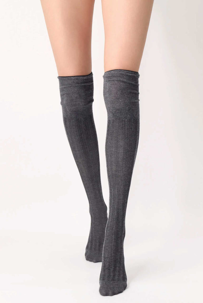 Front view of lady's legs in walking stance, wearing over the knee grey socks.