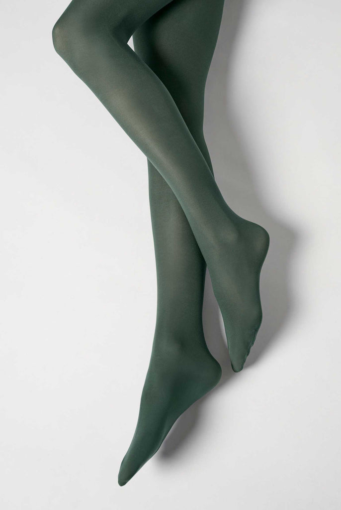 Lady's lower legs, lifted at one knee, in dark green tights.
