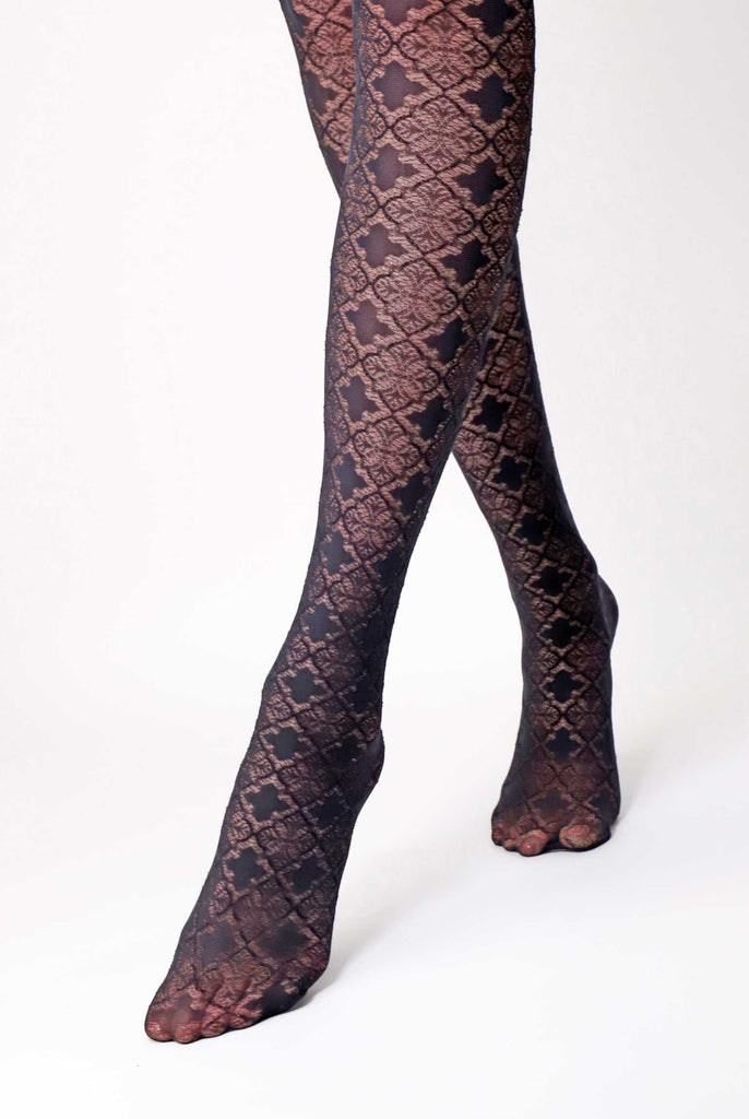 Front view of lady's lower legs, in black jacquard pattern tights.