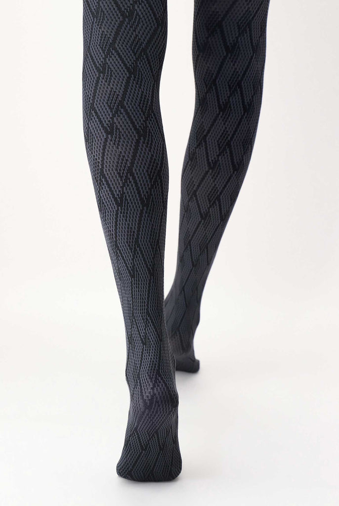 Back view of lady's lower legs wearing grey and black Jacquard pattern tights.