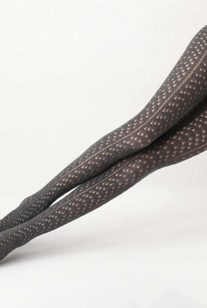 Close up of lady's outstretched legs wearing grey knit tights.