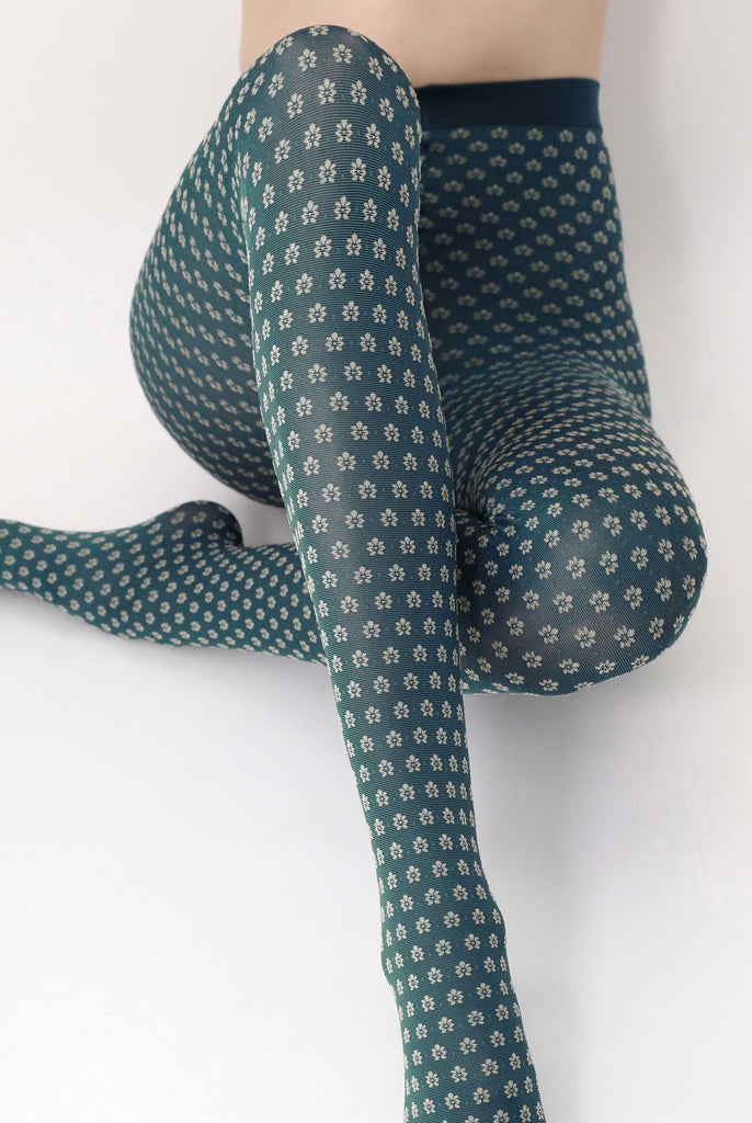 Front view of lady's legs in a stretched sitting position, in green floral tights.