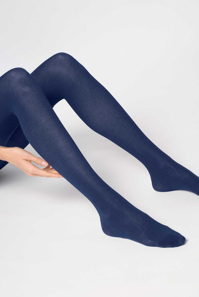 Lady's lower legs extended, wearing blue tights.