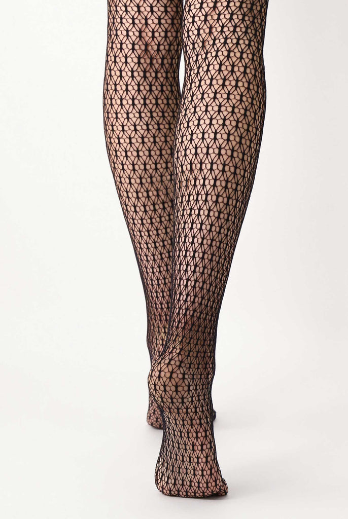 Back view of lady's lower legs, in black mesh tights.