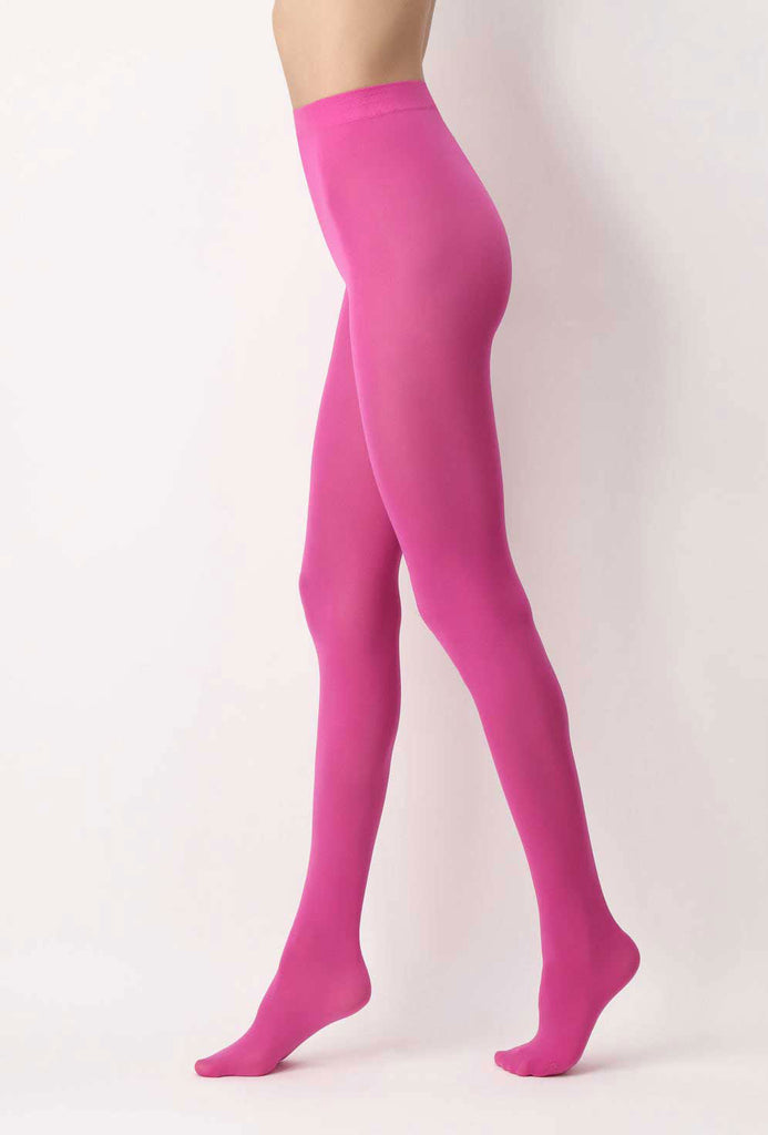 Side view of lady's legs, standing wearing hot pink, opaque tights.