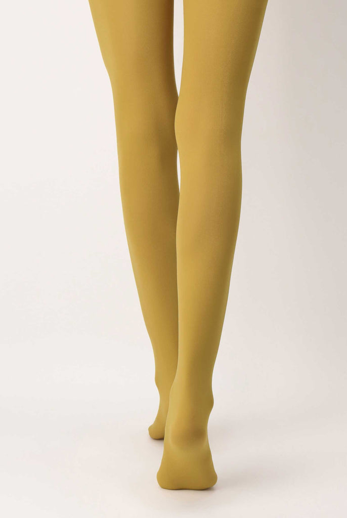 Back view of lady's legs in mustard yellow tights .