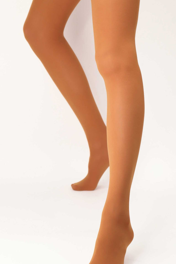 Front view of lady's lower legs with feet apart, wearing rust coloured tights.