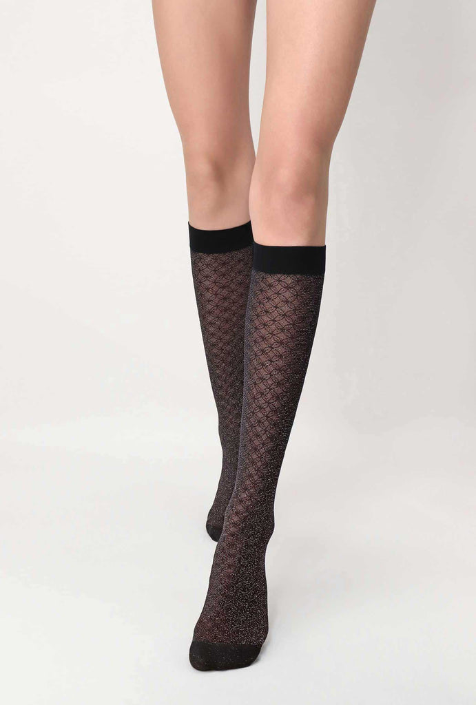 Front view of lady's lower legs, wearing black sparkly, knee high socks/