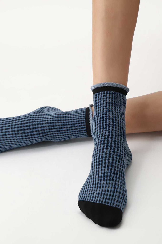 Close up of lady's feet wearing blue, gingham, patterned socks.