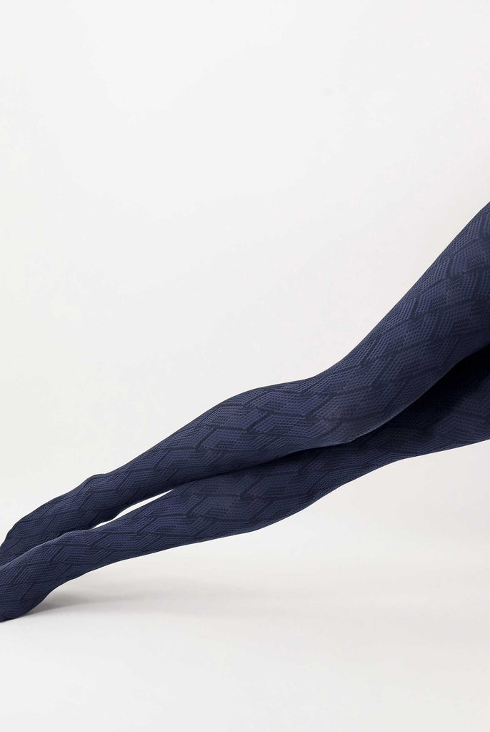 Lady's legs extended, wearing blue jacquard patterned tights.