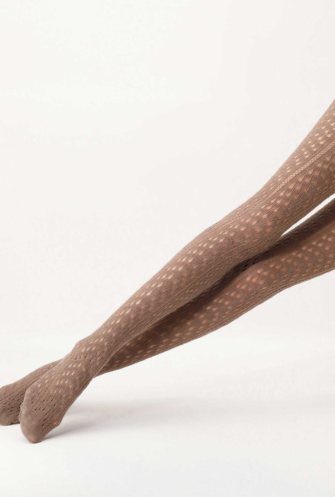 Close up of lady's outstretched legs, wearing toffee coloured tights.