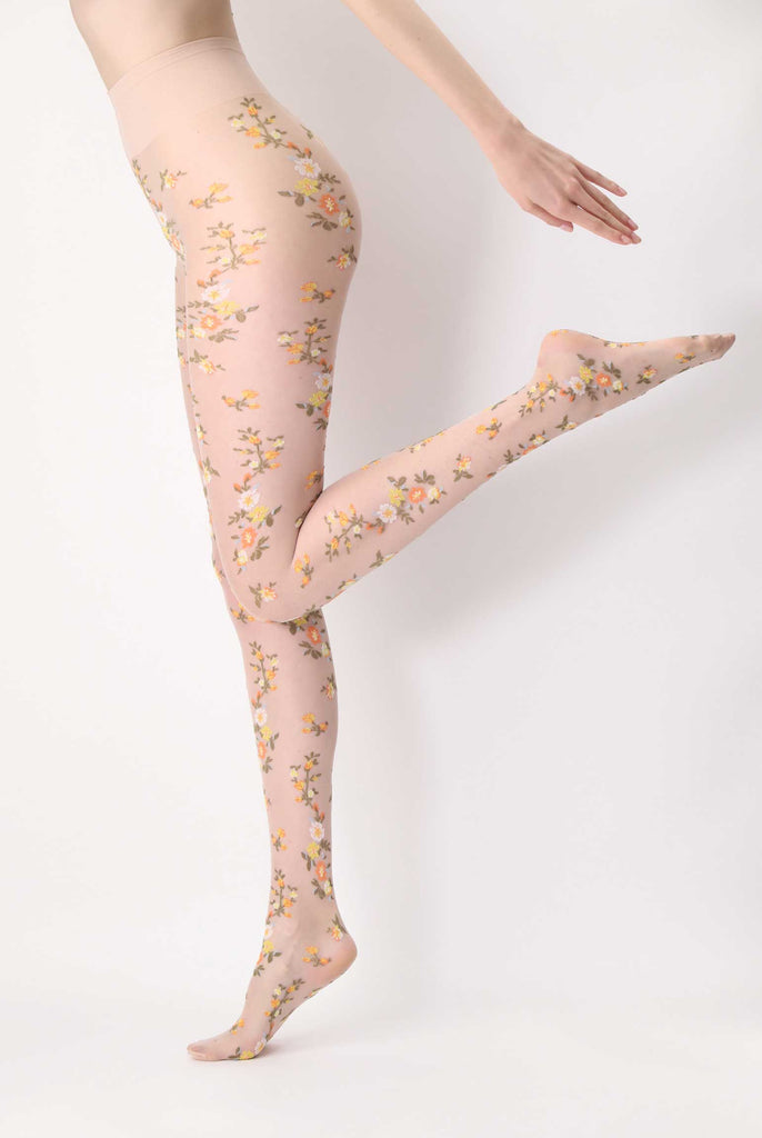 Side view of lady's legs in nude sheer floral patterned tights.