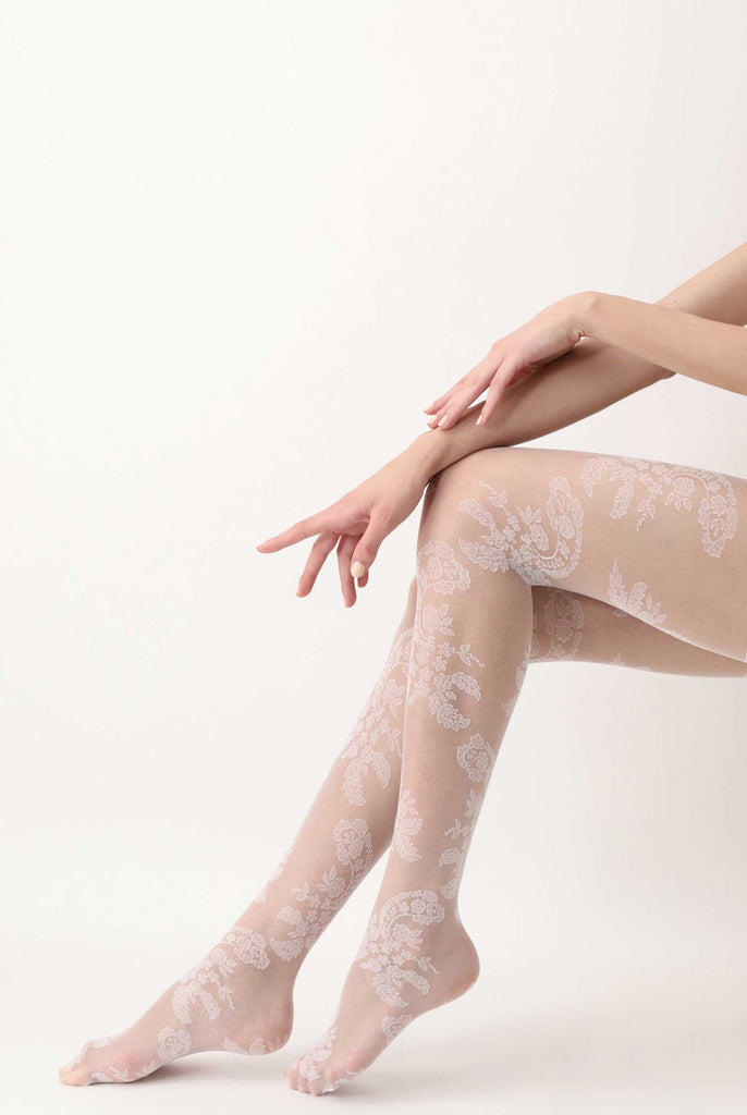 Lady's lower legs in sitting position, wearing white floral lace sheer tights.